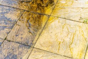 Cleaning of tiles in the garden with pressure washer